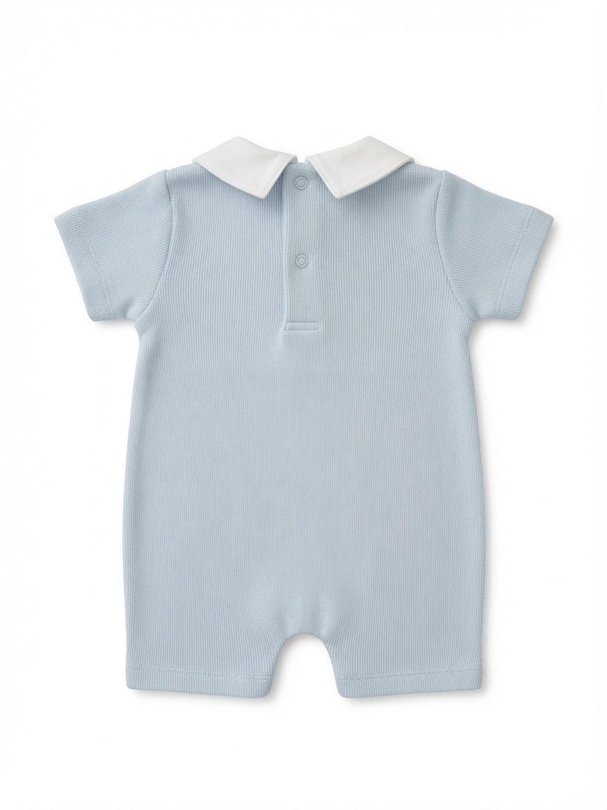 A light blue short-sleeve baby romper with a white collar and a three-button placket, shown flat on a white background from the back.