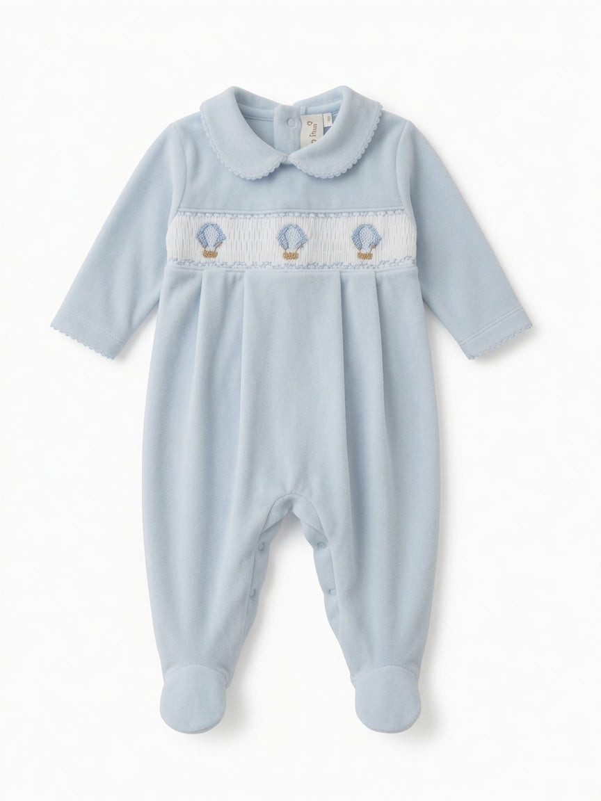 Little Pima light blue smocked onesie with hot air balloon handmade embroidery and Peter Pan collar in plush material.