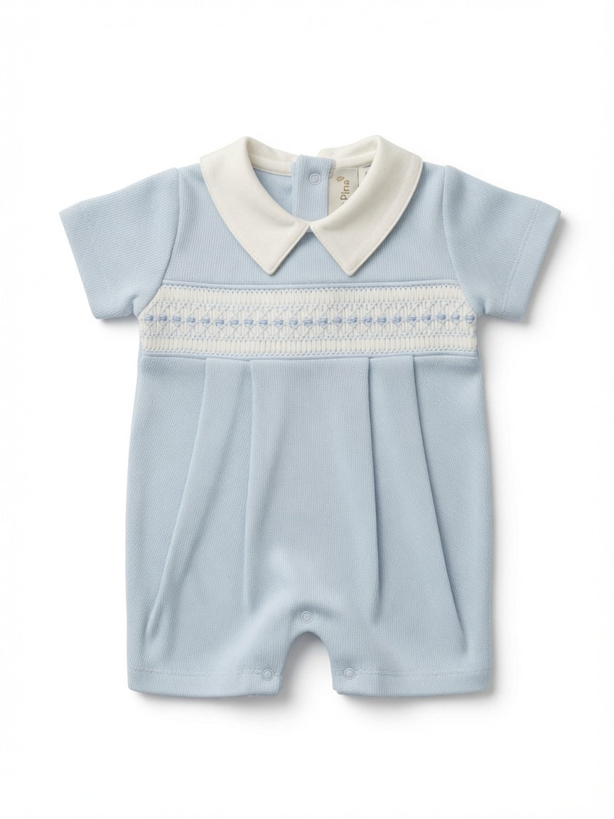 A baby short-sleeve romper in light blue with a white pointed collar and a white smocked chest band, shown flat on a white background.