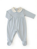 A baby footie in light blue colour, long sleeves, and a contrasting white-colored Peter Pan collar from the front.