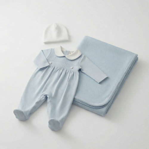 A baby outfit set on a light gray background, featuring a light blue footies with a white Peter Pan collar, a matching light blue blanket, and a small white hat.