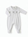 A white long-sleeve baby footie with a smocked chest panel featuring three small hot air balloon hand embroidery motifs, displayed flat against a white background from the front side.