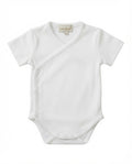 A white short-sleeve baby bodysuit with an asymmetrical wrap-style front and delicate scalloped edges, shown flat against a white background. The brand label 'Little Pima' is visible inside the collar.