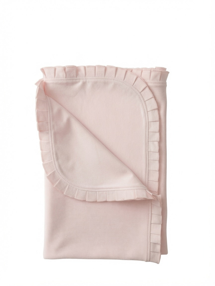 A folded light pink baby blanket with a ruffled border, shown on a plain white background.