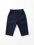 A pair of navy blue pants with an elastic waistband and side pockets, made from Peruvian pima cotton