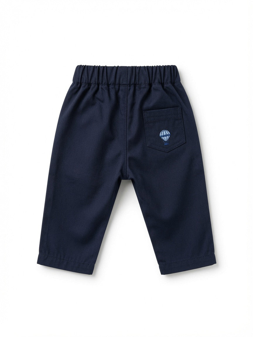 A pair of navy blue pants with an elastic waistband and side pockets, made from Peruvian pima cotton shown from the back