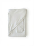 A folded white cotton hooded towel with a diagonal stitched seam and a small pocket on one side, shown on a plain white background.