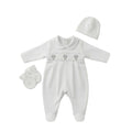 A white baby footie set with long sleeves, a Peter Pan collar, three small hot air balloon hand-embroidered motifs across the chest, a matching hat, and a pair of mittens, laid out on a clean white background.