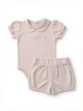 A baby girl's two-piece outfit set consisting of a pink short-sleeve bodysuit with a Peter Pan collar and matching textured bubble shorts, laid flat on a white background.